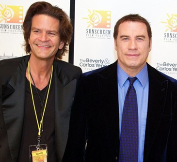 Tom Garrett with John Travolta at Sunscreen Film Festival. Image courtesy of celebrityimages.org.
