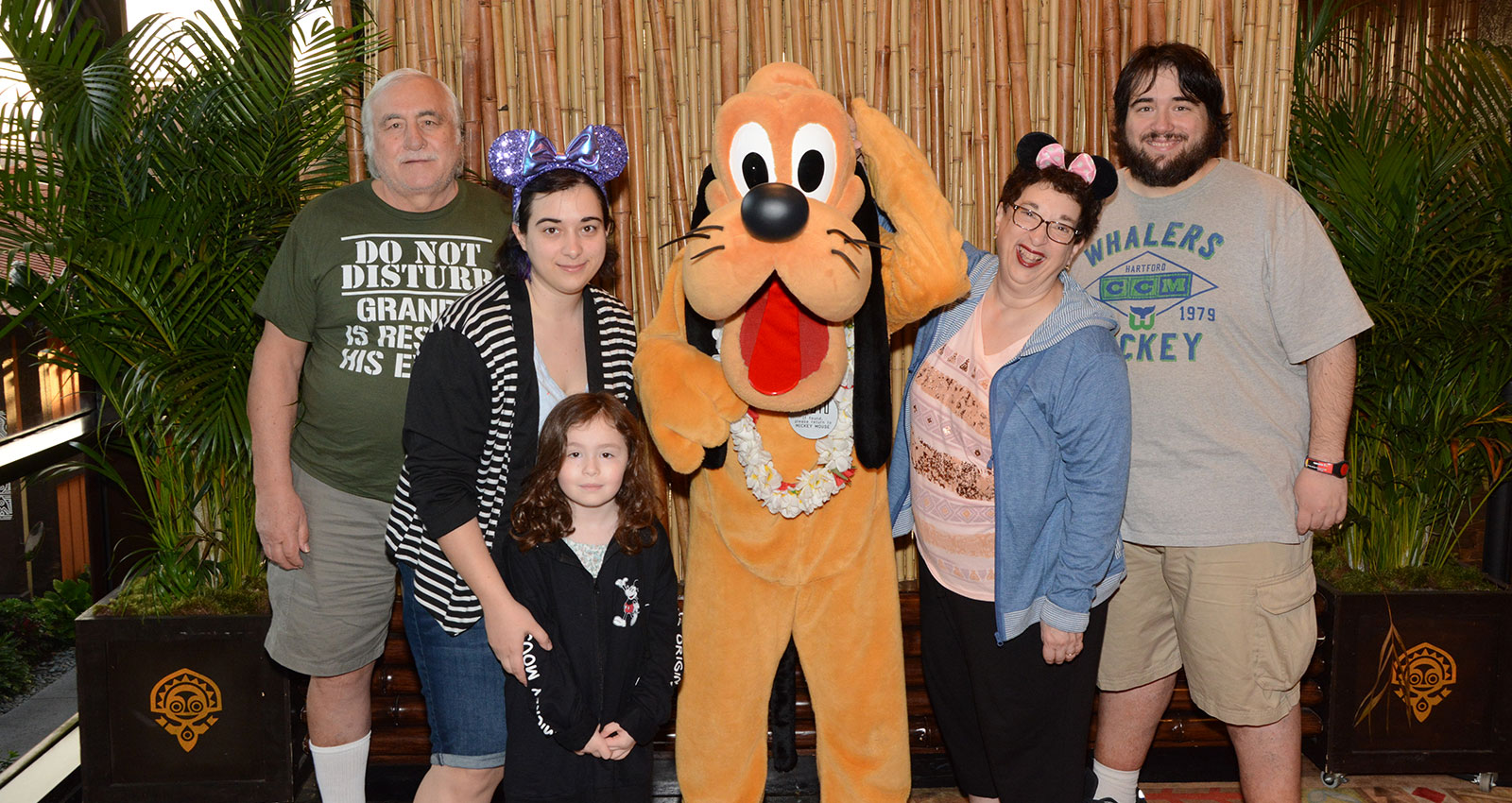 Image of Paula Cappuccia and her family meet Pluto.