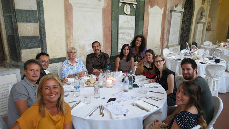 Lara Pugi (center) and her fellow Chargers share a meal in Italy.
