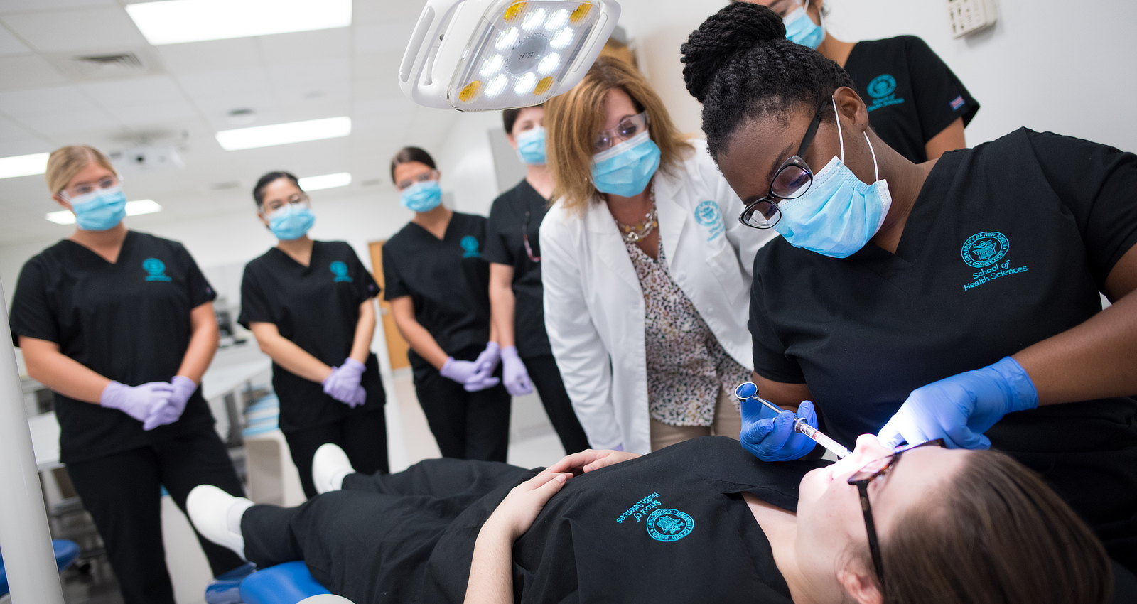 Dental students working on a patient