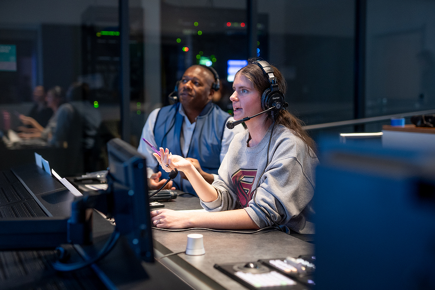 Student wearing headset in communication studio