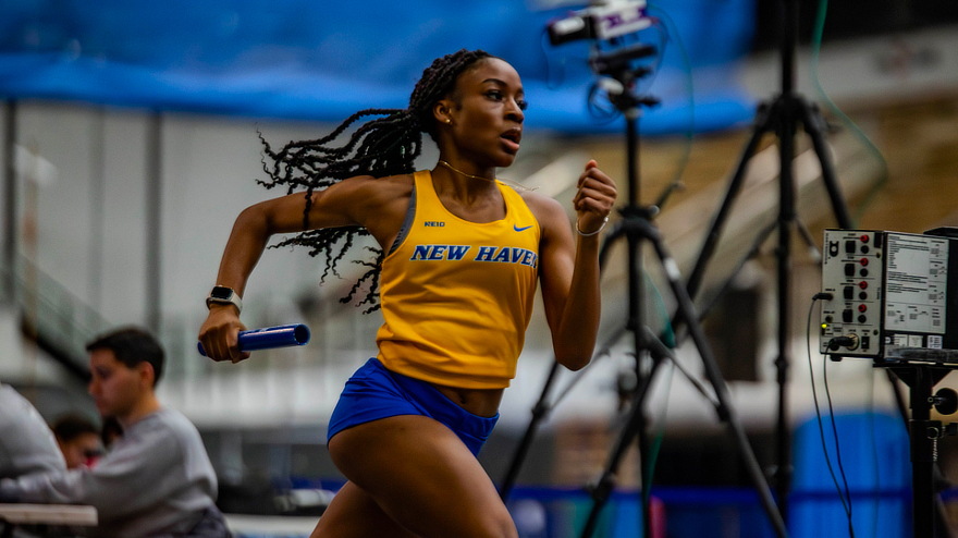 Hollisa Liburd ’27 running with baton