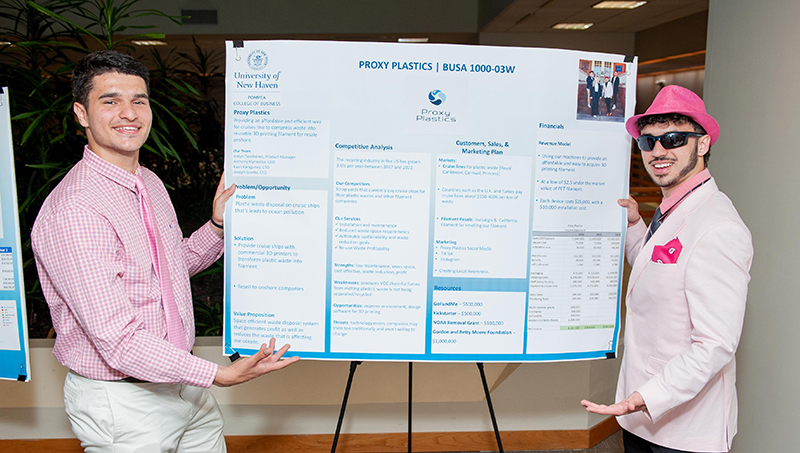 Anthony Klymenko ’25 (right) and Kaan Karaguney ’25 shared their “Proxy Plastics” poster at the expo.