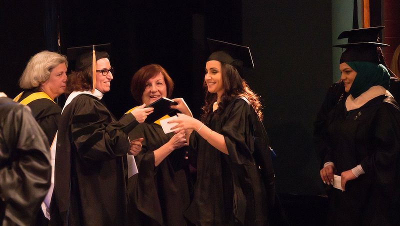Marwa Lahlou’s mother Halima Belemlih, Ph.D., presents her diploma