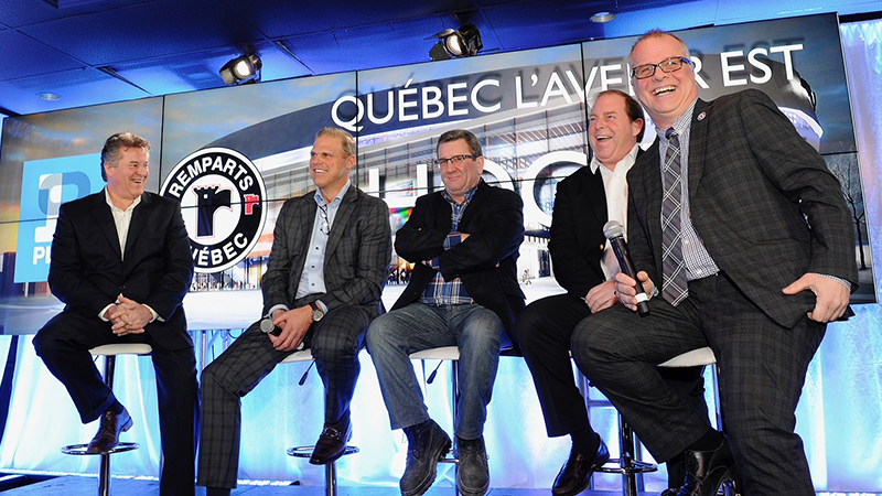 Ben Robert ’81, ’83 MBA (second from left) at a press conference in Quebec.