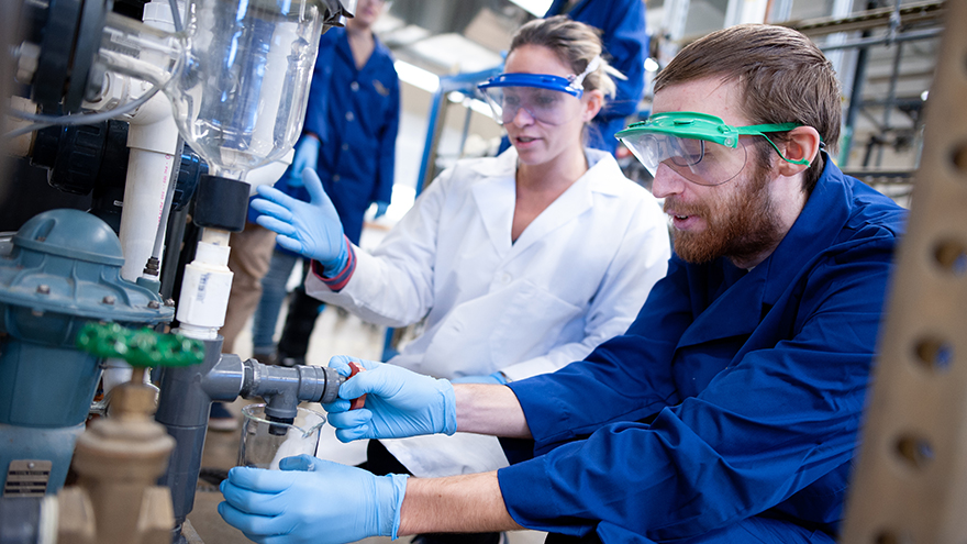 Students pour chemicals.