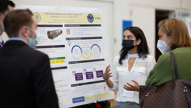 Paola Garcia Gonzalez ’22 (center) discusses her team’s project at the expo.