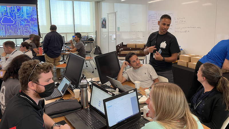 Mehdi Mekni, Ph.D. speaks to Joel Padilla (center, in grey shirt) and other educators as part of GenCyber Teacher Academy.