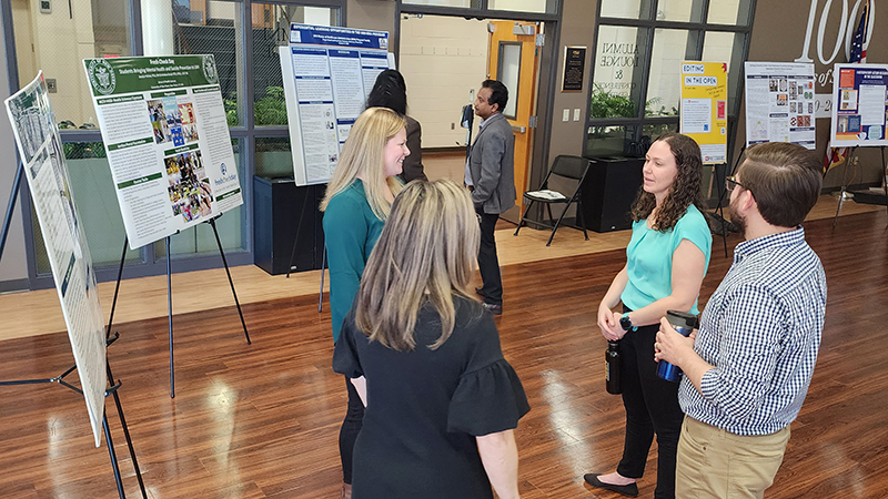 Faculty discuss what they’ve learned at the Project-Based Learning Poster Showcase.