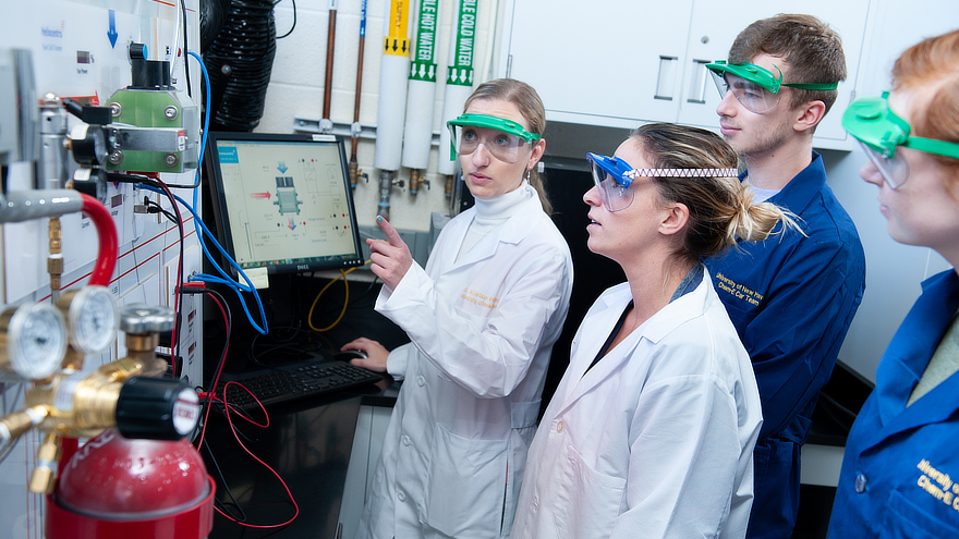 Chemical Engineering students with professor in lab