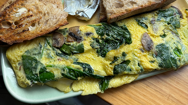 Spinach and mushrooms are the OG superheroes of breakfast. Toast’s just here for the ride.