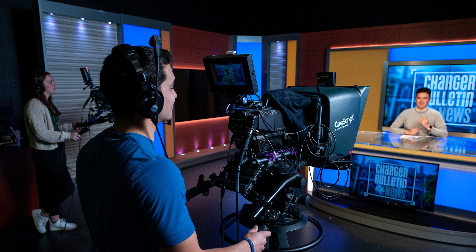 Student using TV camera in studio
