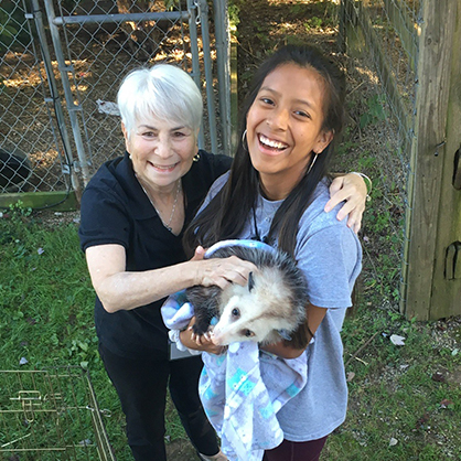 Tessa McDonald ’26 and one of her fellow volunteers with an opossum named Jodie. 