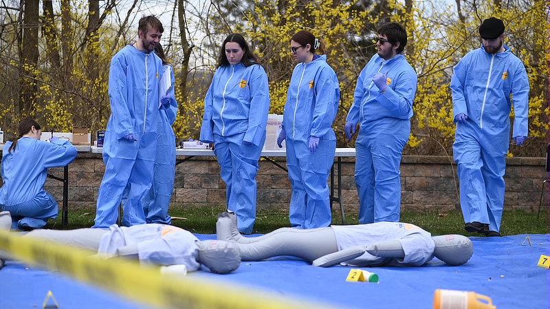 Students process a mock crime scene