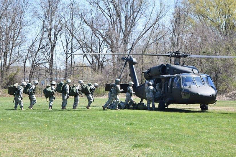 Students in the ROTC program at the University of New Haven entering a helicopter.