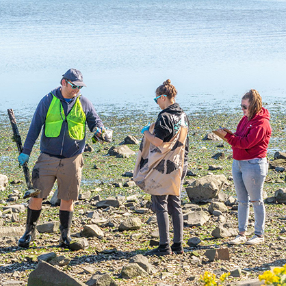 Students collect trash along the waterfront in New Haven