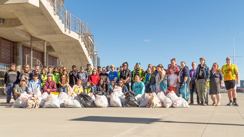 Dozens of Chargers and members of the local community collected trash as part of the cleanup event.