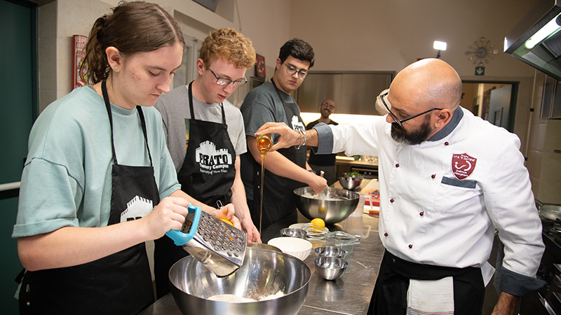 A local chef teaches students how to prep a meal.