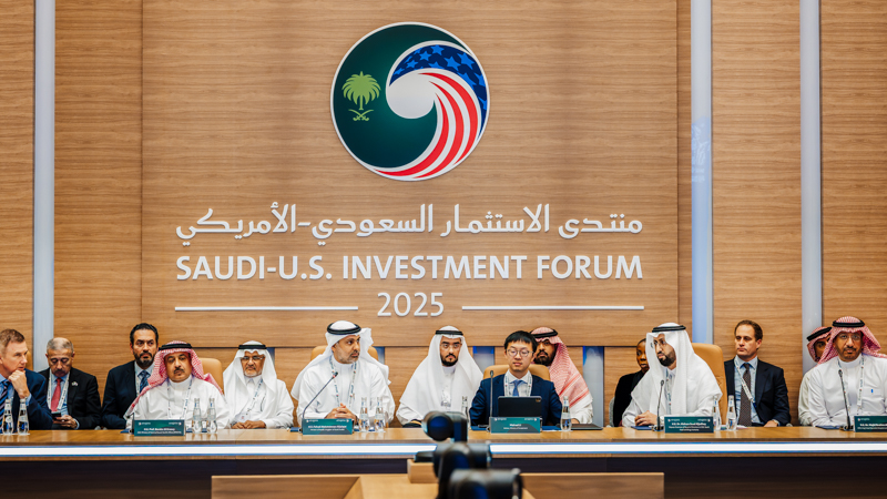 University of New Haven President Jens Frederiksen was invited to attend the Saudi-U.S. Investment Forum in Riyadh. Many men in formal attire gather at a long table, a wood clad wall is behind them with text that reads Saudi-U.S. Investment Forum 2025.