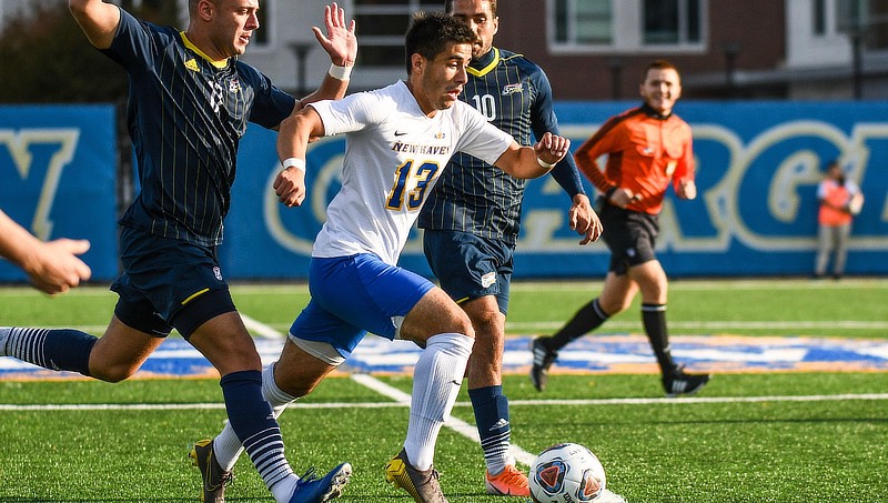 Image of JP Viruet ’22 (No. 13) in a match against Southern New Hampshire University.