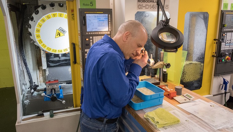 Image of Mark Rohlfs in front CNC machining center.