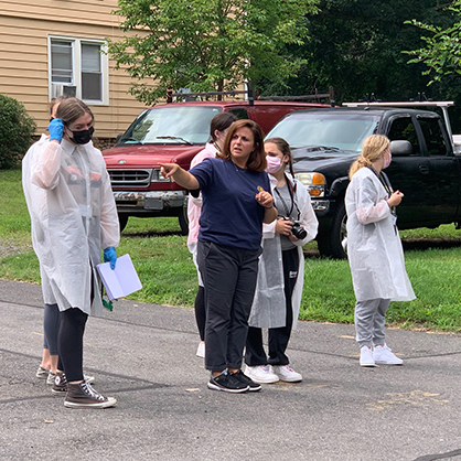 Maria Torre, M.S., instructs students during the mock crime scene investigation.