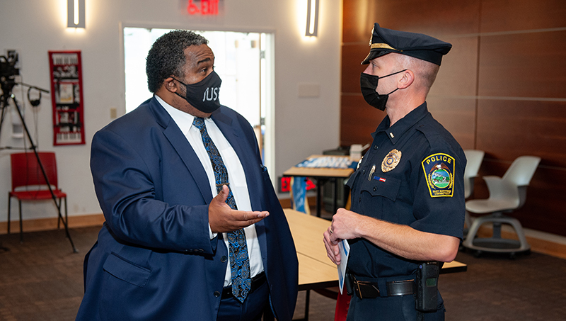 Lorenzo Boyd, Ph.D. shaking hands with an officer.