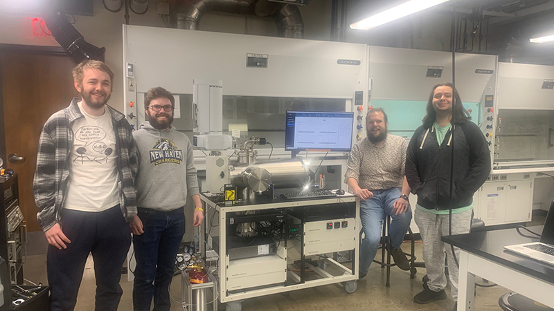 Left to right: Sean Allen '23, '24 M.S., James McEwan ’24, Dr. Nathan Seifert, and Dominick Panzino ’23, ’24 M.S. with the microwave spectrometer.