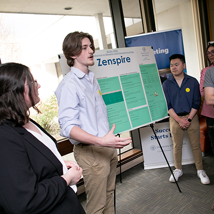Students discuss “Zenspire” during the poster competition. 