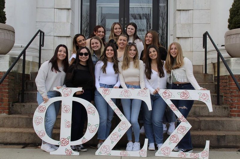Phi Sig group standing on stairs