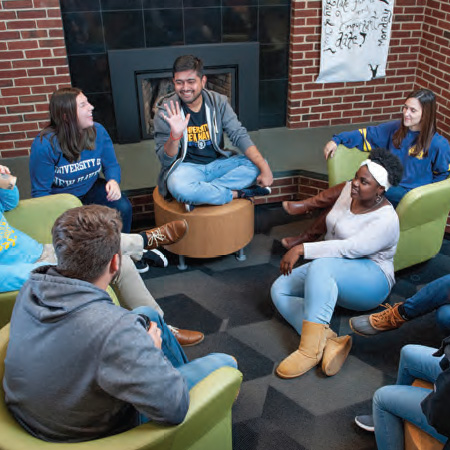 Students sitting in a res hall lounge.