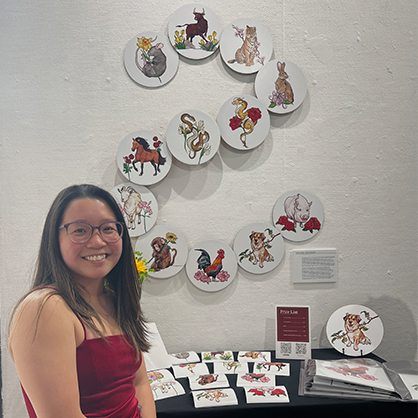Nichole Licata ’23 with her series of illustrations depicting the animals that make up the Chinese zodiac.